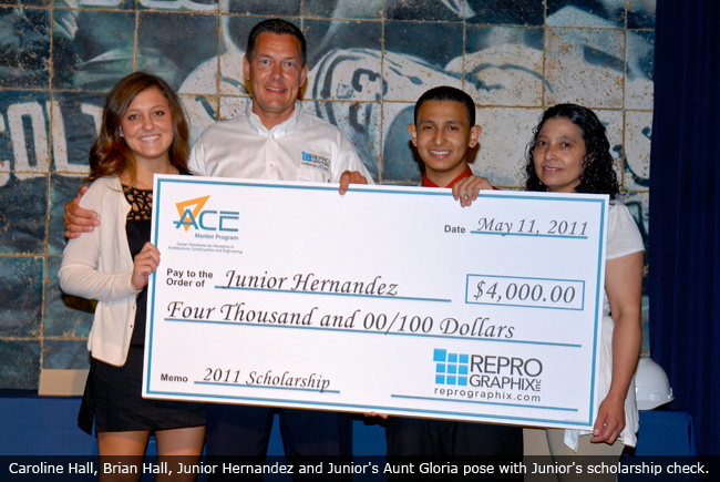 Caroline Hall, Brian Hall, Junior Hernandez and Junior's Aunt Gloria pose with Junior's scholarship check.